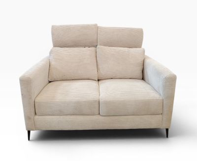 the two seater sofa is made of fabric and has two pillows