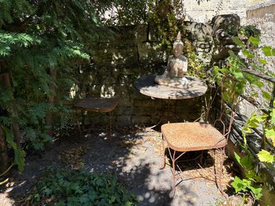 a small patio with a table and two chairs in it
