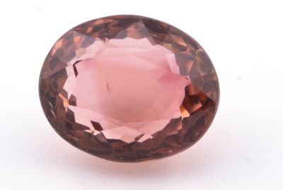 un gros plan d'un quartz rose posé sur une surface blanche