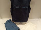 a mannequin with a blue vest and pants on a table