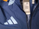 a close up of a blue jacket with a tag on it