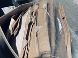 a box full of cardboard sitting on the floor