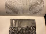 an open book with a picture of a group of people standing in front of it