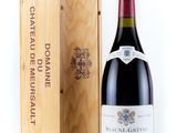 the bottle of red wine is next to a wooden box