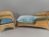 pair of wicker lounge chairs with blue cushions on a grey background