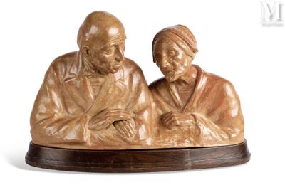statue of a man and a woman sitting on a wooden base