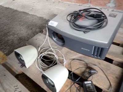 two speakers sitting on a pallet next to some wires