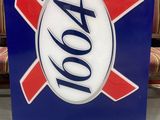 blue and red sign with a white and red xo logo on it