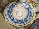 many plates and bowls in a box on the table