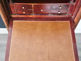 a wooden desk with a drawer on top of it