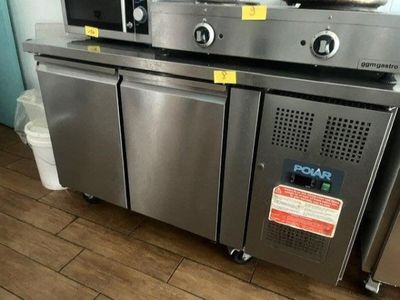 two microwaves sitting on top of a stainless steel counter