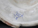 a close up of a white plate with a blue design on it