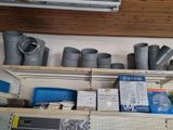 many different types of pipes and fittings on the shelves