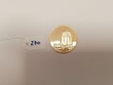 a close up of a gold coin with a price tag on it
