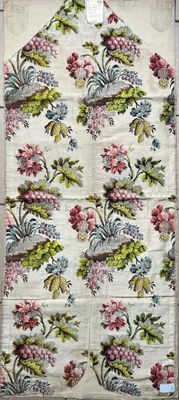 a large floral print bag hanging on a clothes rack