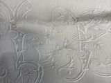 a close up of a bed with a white comforter on it