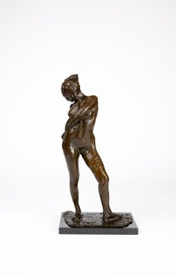 bronze statue of a man holding a tennis racquet on a marble base