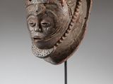 a carved head of a man on a stand