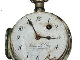 a close up of a pocket watch on a white background