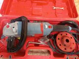 a red box with a tool in it on a table