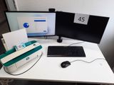 a computer desk with two monitors and a keyboard on it