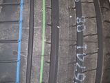 a close up of a tire on a white surface with blue and green stripes