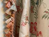 a close up of a curtain with tassels on it