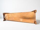 a wooden box with a wooden handle on a white surface
