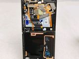 a cell phone that has a broken screen and is sitting on top of a table