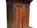 an old wooden armoire with carvings on the top of it