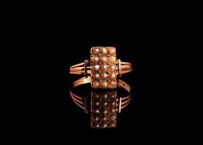 a close up of a gold ring with pearls on a black surface