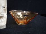 a small glass bowl sitting next to a small glass bowl