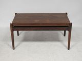 a small wooden table with a drawer on top of it