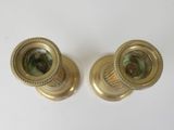 pair of antique brass candlesticks with green glass in the middle