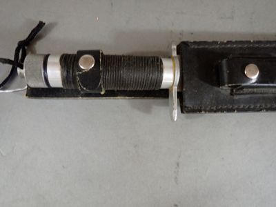 a knife that is laying on top of a leather case