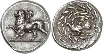 a close up of a coin with a horse and a bird on it