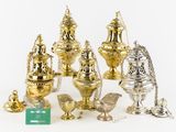 several different types of silver and gold vases on a white surface