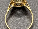 a close up of a gold ring with a diamond in the center