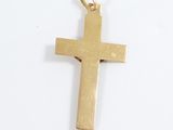 a gold cross on a white surface with a white background
