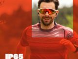 a man running in a red shirt and headphones
