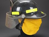 a close up of a fireman ' s helmet with a face shield on it