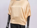 an image of a mannequin mannequin wearing a gold top and black pants