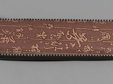 leather wallet with writing on it on a gray surface