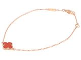 a bracelet with a red flower on a gold chain