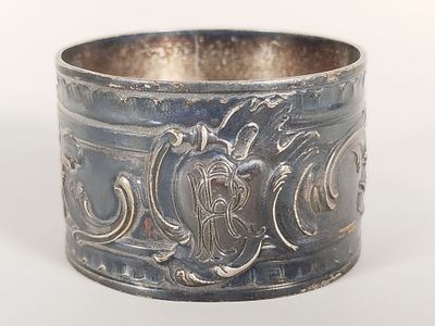 an antique silver bracelet with a design on the side