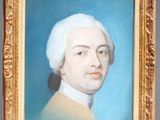 portrait of a man with white hair in a gold frame