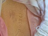 a close up of a woman ' s breast with a pink scarf