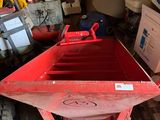 a red dumpster sitting in the middle of a pile of boxes