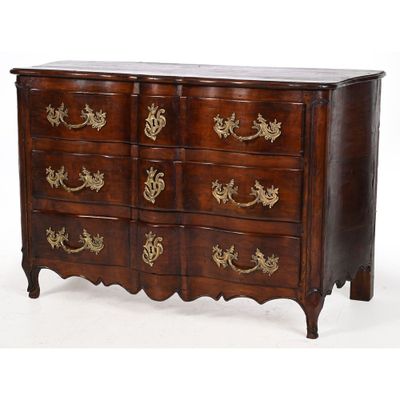 an image of a chest of drawers with gold decorations on the drawers