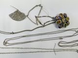 a lot of jewelry that is laying out on the table